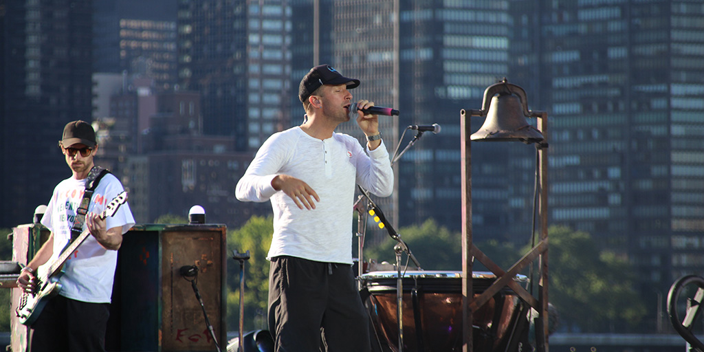 Coldplay's Guy Berryman (left) and Chris Martin (center) performing during soundcheck and tech rehearsal.