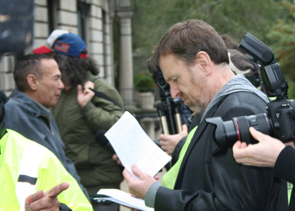 Colin Quinn going over his notes prior to speaking at the George Carlin Way ceremony in October 2014. Gilbert Godfried and Judah Friedlander in background.