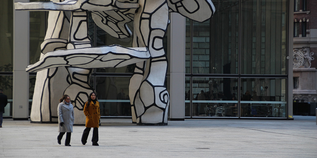 Background players walking to their marks in Fosun Plaza