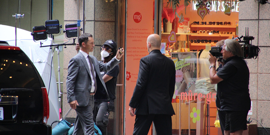 Jeffrey Donovan flashing his badge on the set of Law & Order