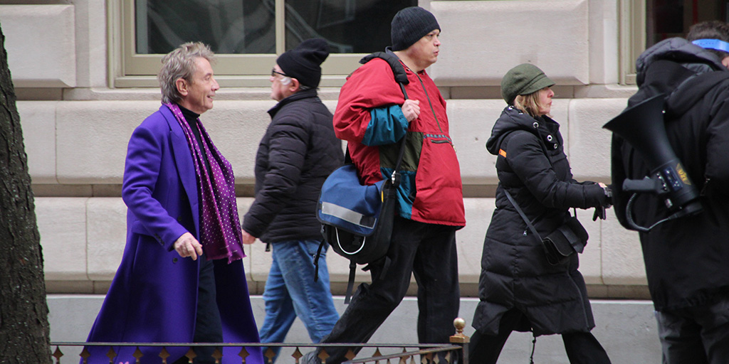 Martin Short walking into a building on 86th Street on the UWS during production of Only Murders in the Building.