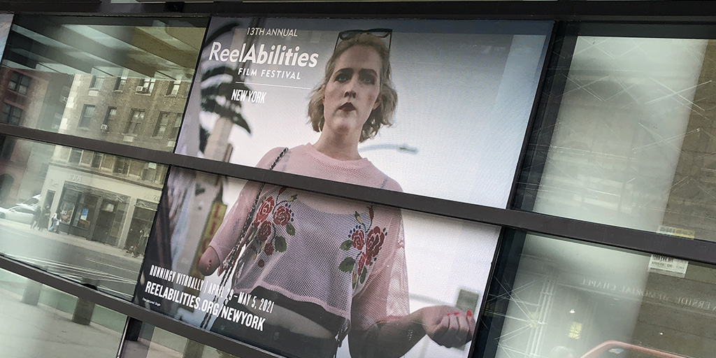 Festival poster for the ReelAbilities Film Festival displayed at the Marlene Meyerson JCC in Manhattan.