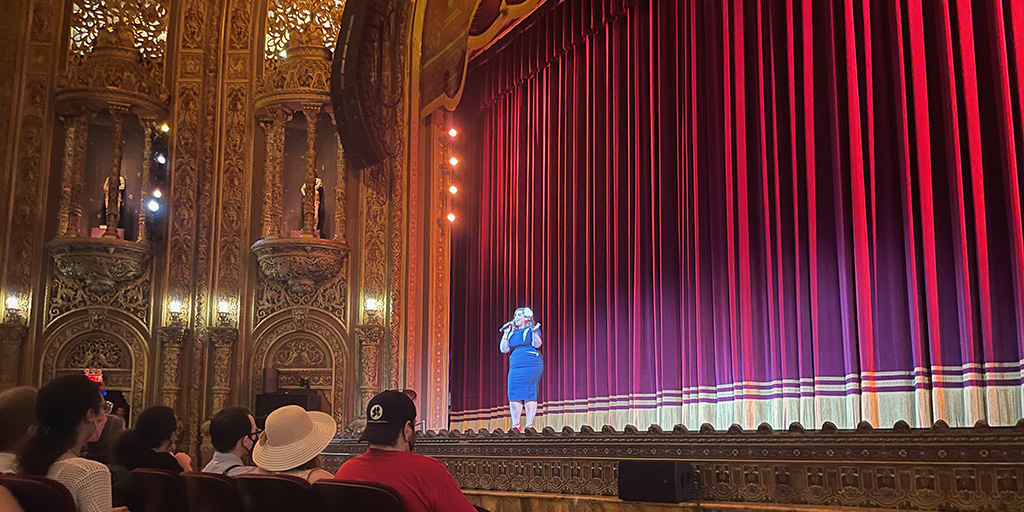 Performer on stage singing during Raiders of the Lost Ark event - June 2022